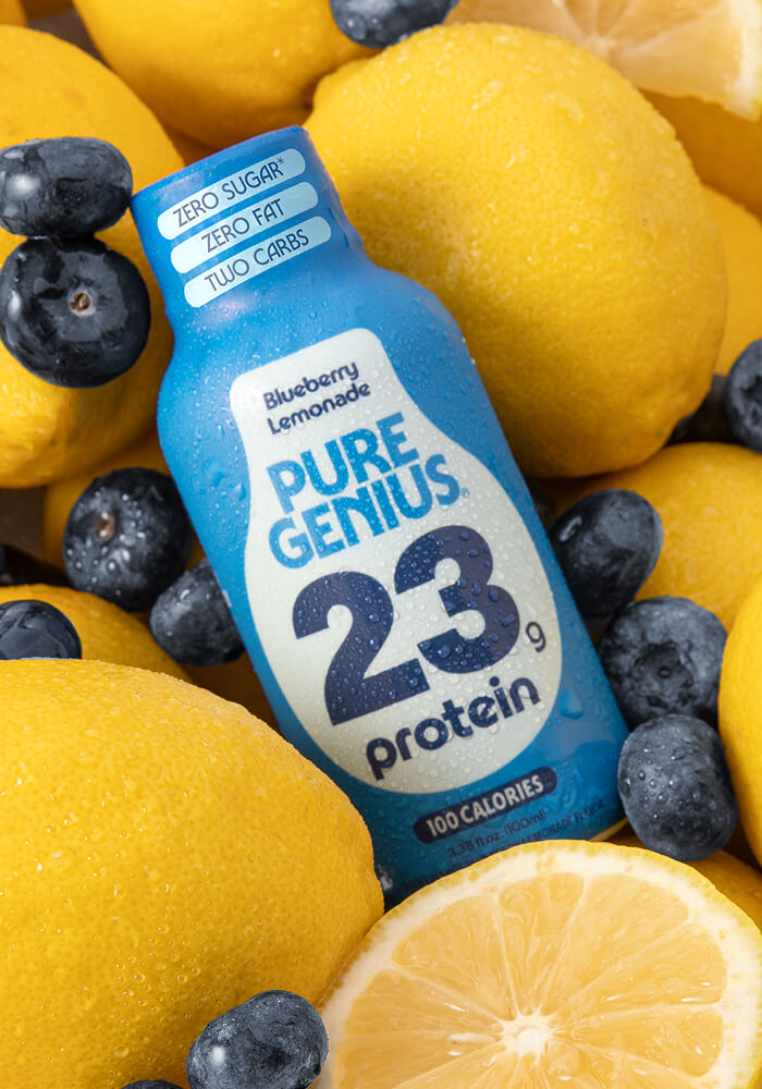 Pure Genius Blueberry Lemonade protein shot on lemons and blueberries