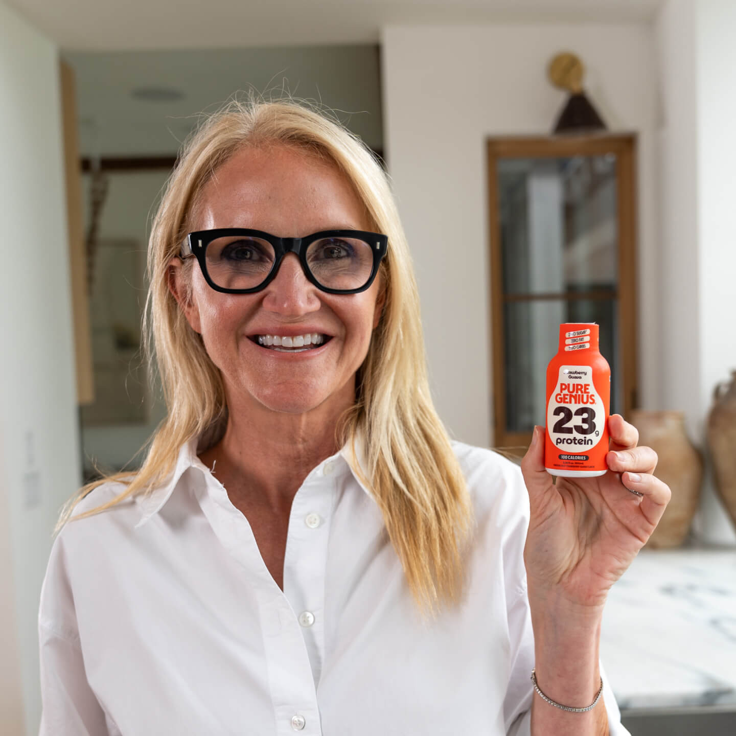 Woman drinking a Pure Genius protein shake