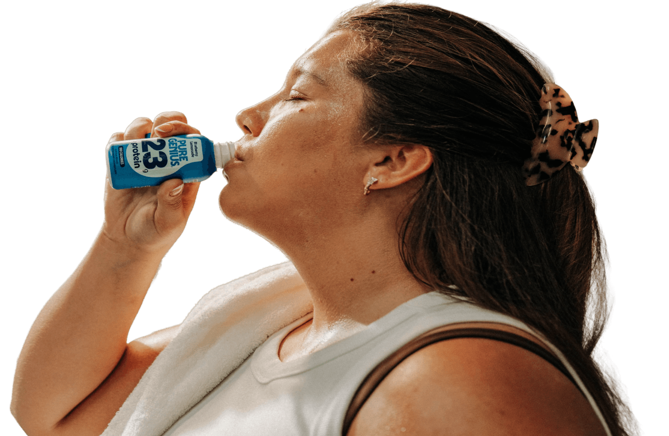 Woman drinking a Pure Genius Blueberry Lemonade protein shot